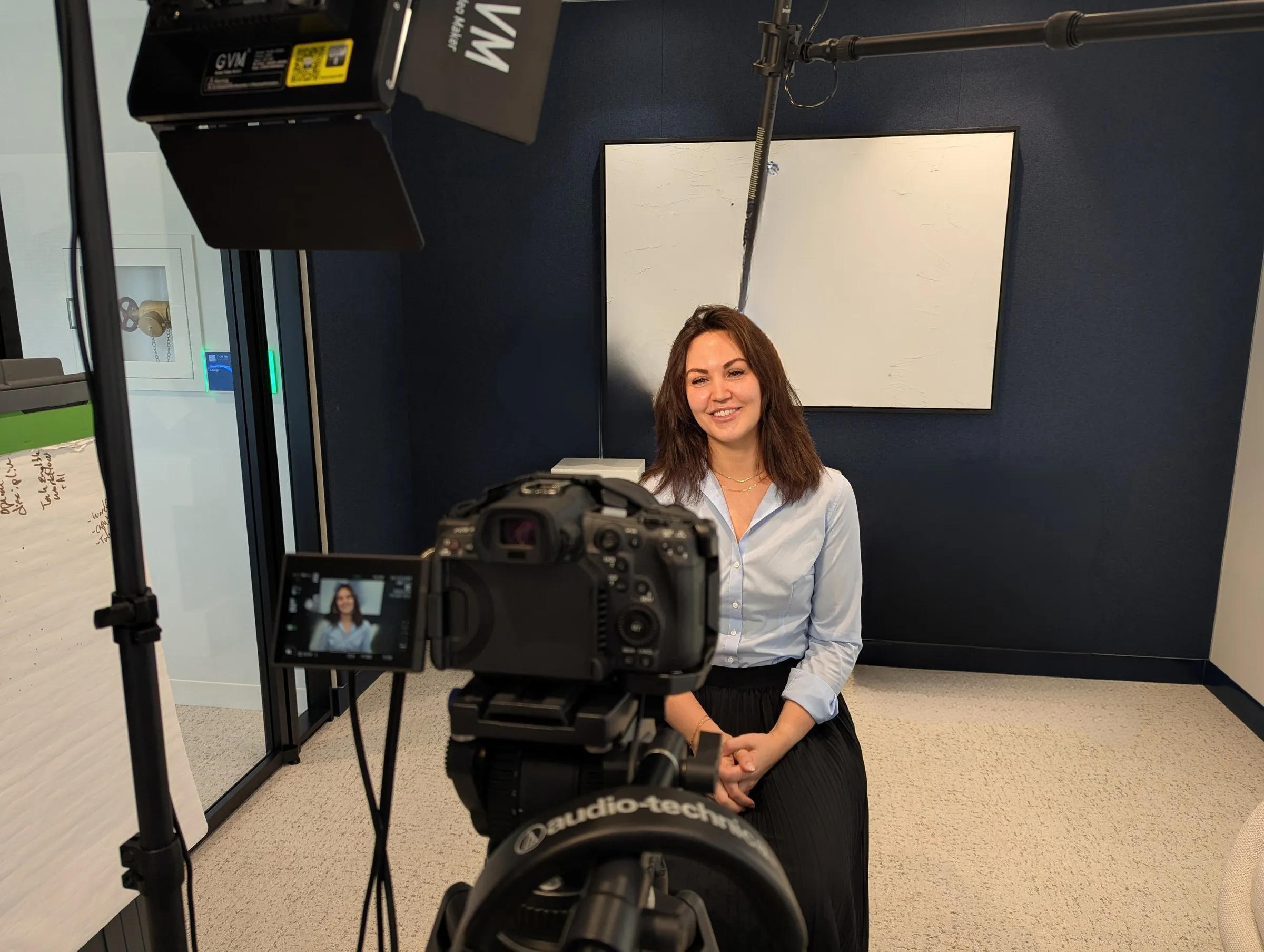 Eryn Peters on a film set, mid-interview